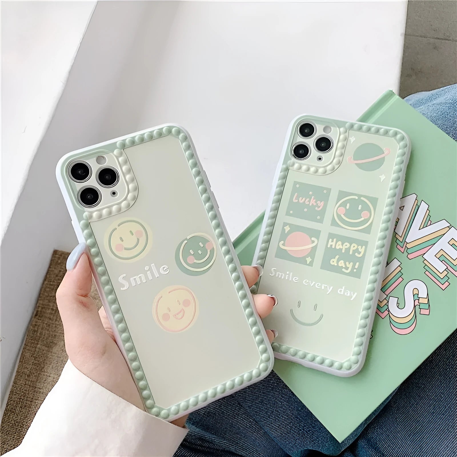 Green TPU iPhone case showing geometric smiley face design with polka dot frame on back