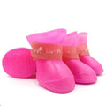 Set of four anti-slip pet rain shoes in various colours with rubber soles for waterproof dog paw protection.