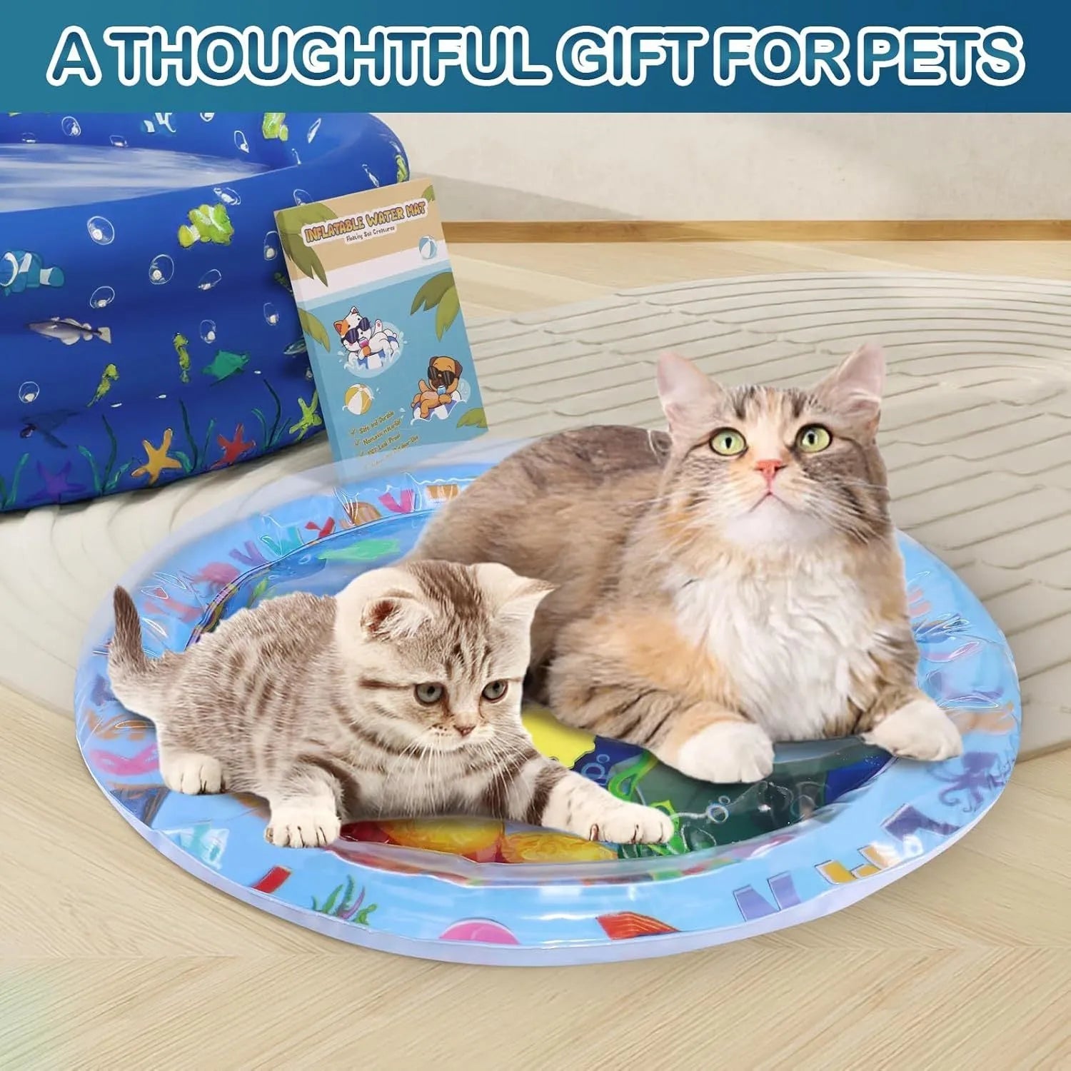 A square blue water sensory playmat for cats on a floor, showing floating fish toys inside the transparent PVC cushion.