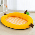 Green pet cooling mat with a raised fruit-shaped backrest for dogs and cats.