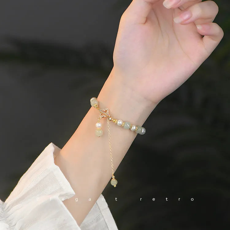 Women's bracelet with round Hetian jade pendant on gold-tone electroplated chain, Chinese-style design