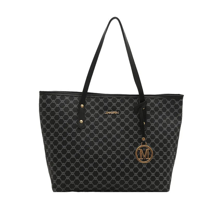 Soft PU leather ladies' shoulder bag in black showing contrast stitching and a top handle.