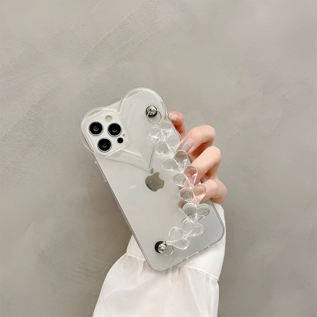Transparent iPhone case with an attached clear love heart charm bracelet on a TPU shell.