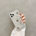 Transparent iPhone case with an attached clear love heart charm bracelet on a TPU shell.