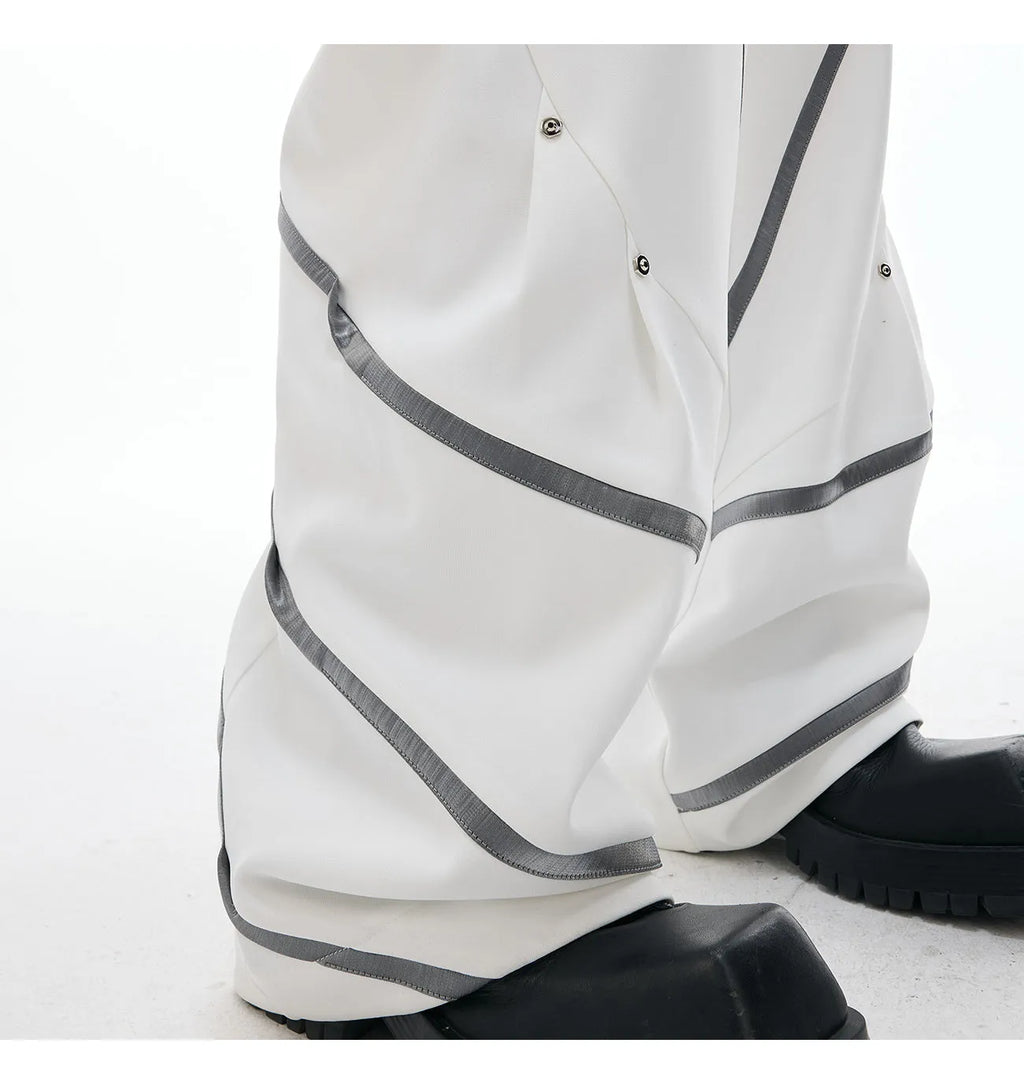 Men's black polyester trousers with metal striped rivet pleats and three-dimensional tailoring.