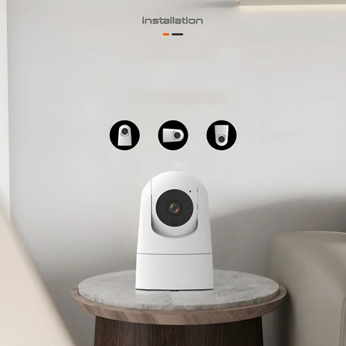 White indoor 5G security camera with tilt head on a desk next to EU UK US power plugs.