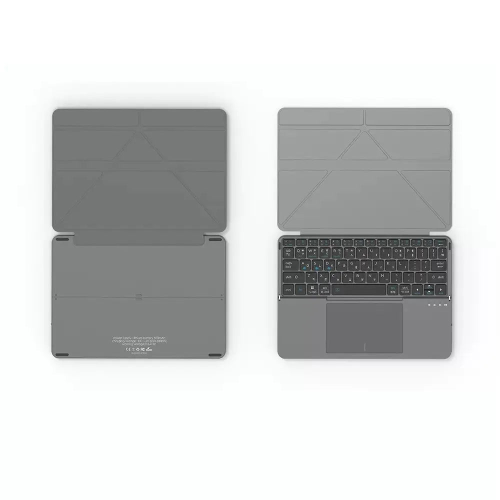 Grey folding Bluetooth keyboard shown open next to a mobile phone.