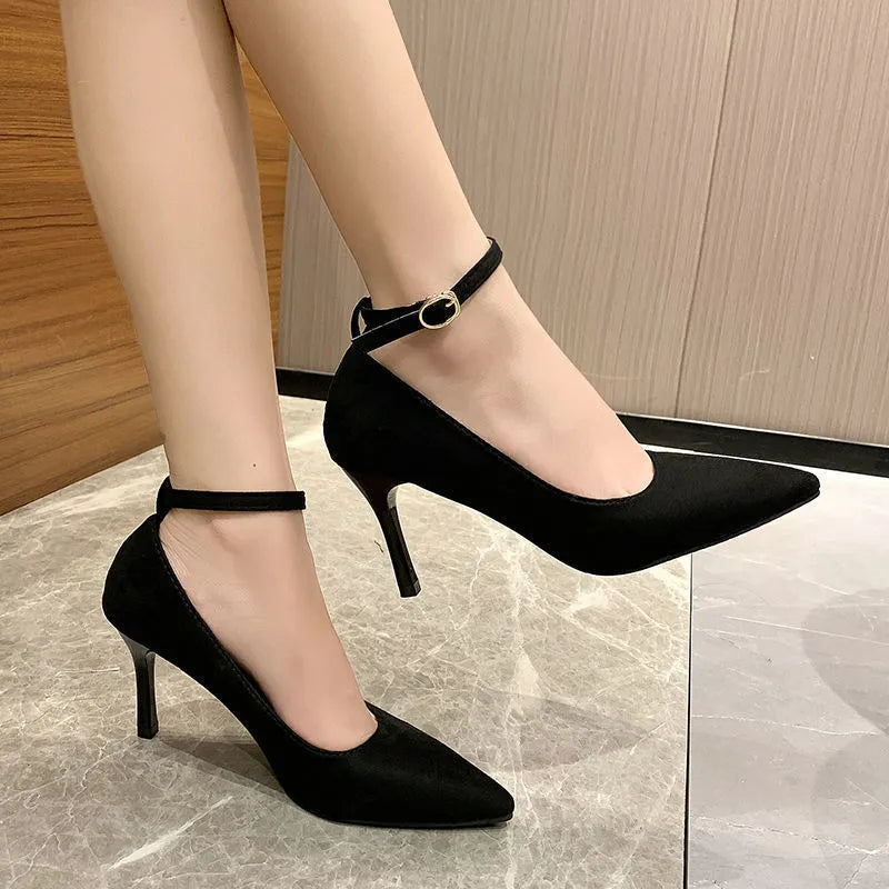Women's black and creamy white stiletto heel pump shoes with an ankle buckle, shown in 5cm and 8cm heel heights.