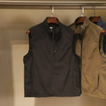 Men's solid colour nylon vest with side pockets in a straight, cardigan-style cut.