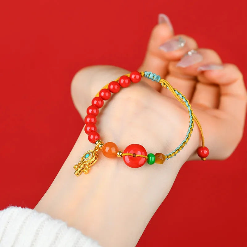 Emperor red sand cinnabar bracelet with hand-woven geometric patterns and peace buckle closure