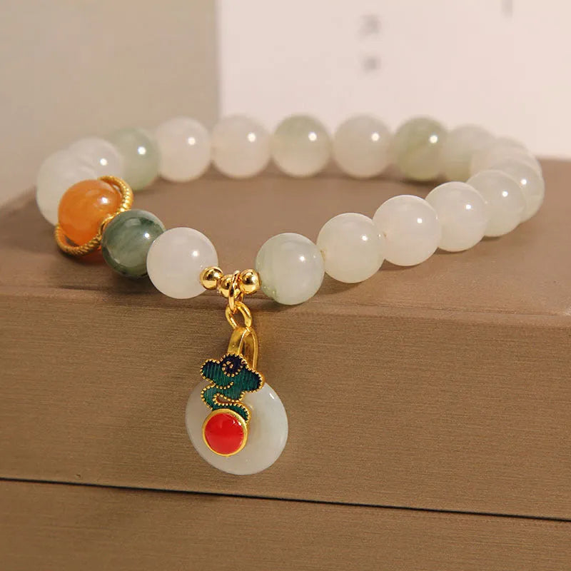 Women's ice jade crystal bracelet with pearl accents and a Xiangyun peace jade buckle.
