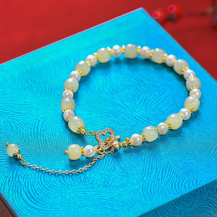 Women's bracelet with round Hetian jade pendant on gold-tone electroplated chain, Chinese-style design