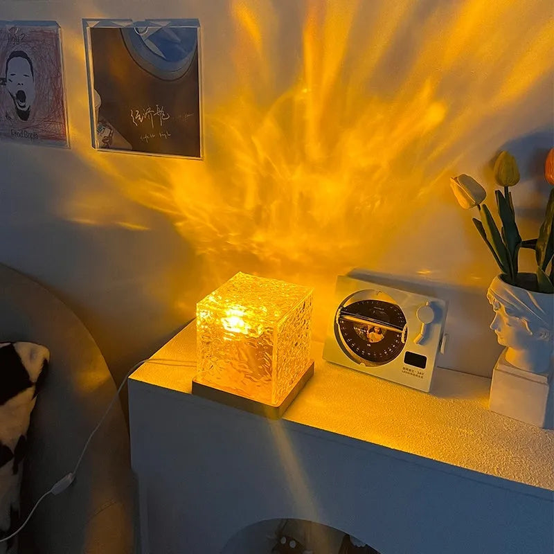 LED water ripple projection night light with remote control on wooden table
