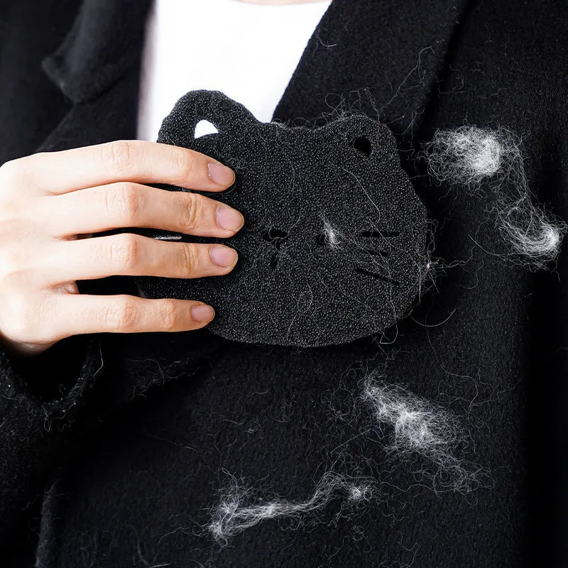 Two black bear-shaped sponge cleaning balls for pet hair removal in laundry