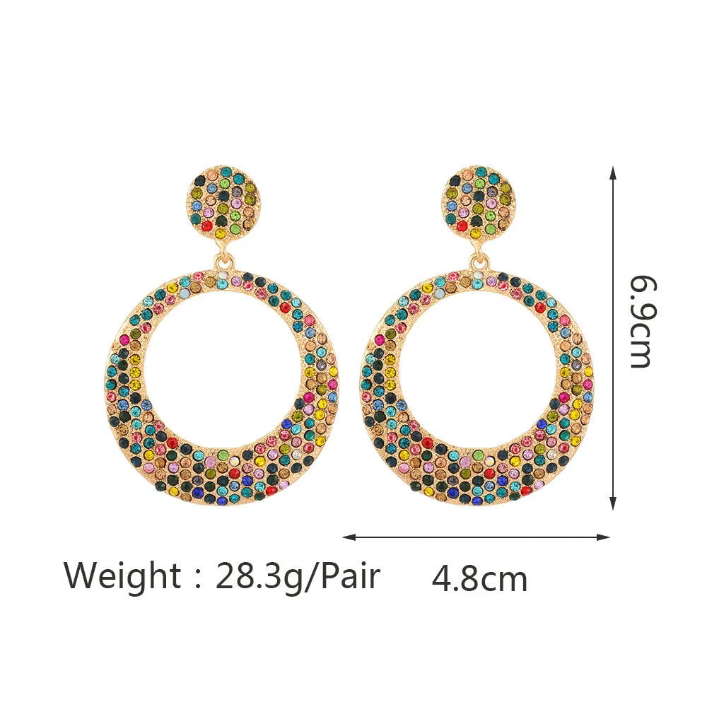 Large round cartoon-style alloy drop earrings with colourful diamond pendant on a white background.
