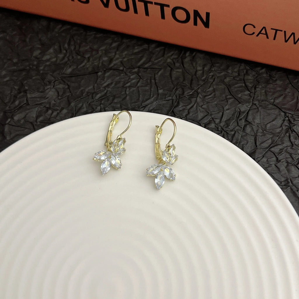 Platinum colour leaf-shaped drop earrings with shiny inlaid zircon details for women.