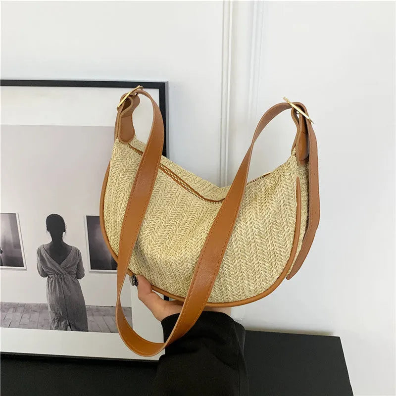 Straw woven crossbody bag showing woven texture and internal phone compartment