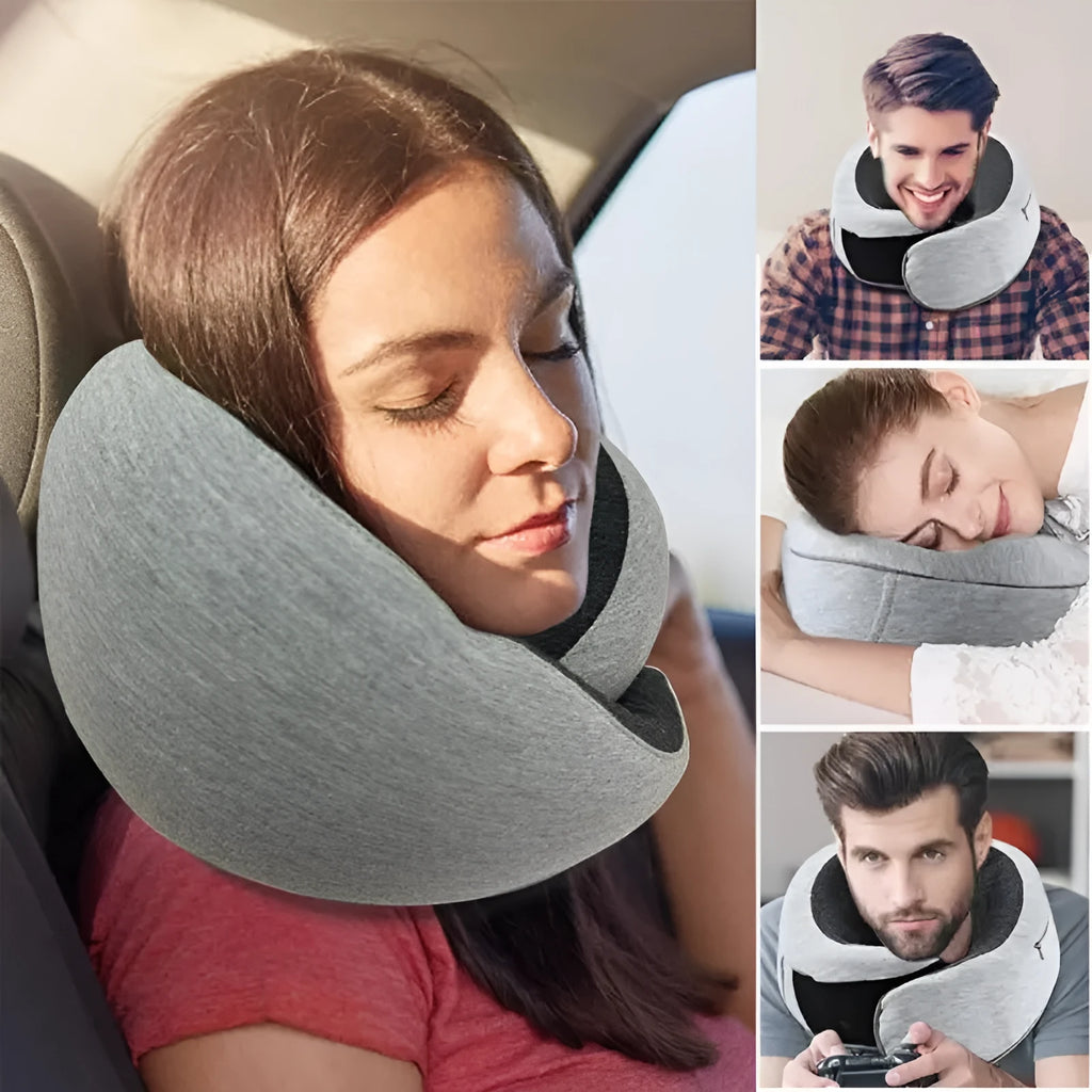 U-shaped navy blue memory foam travel neck pillow rolled up next to a mobile phone showing compact size