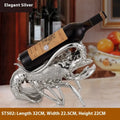 Lobster-shaped wine rack ornament in rose gold holding a wine bottle