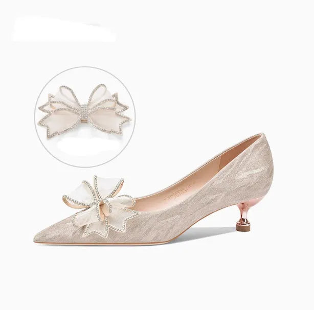Champagne coloured sequinned pointed toe stiletto high heel pump on a white background.