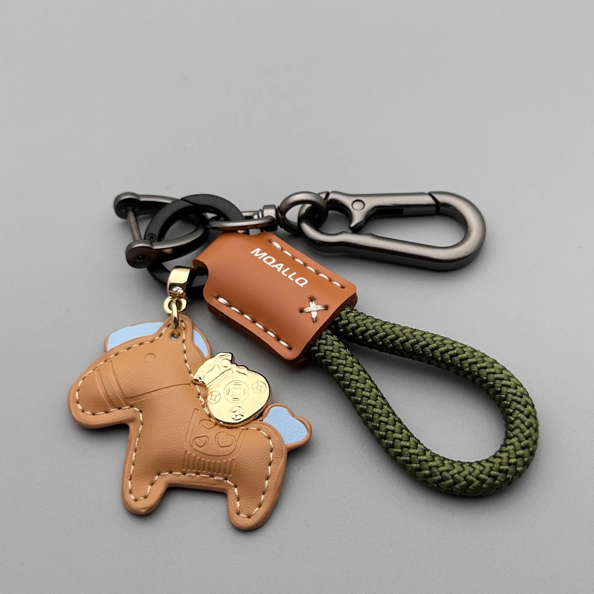 Handmade brown cowhide key ring pendant with a zinc alloy pony buckle on a green flanelle rope.