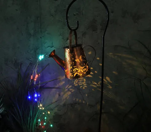 Solar-powered iron garden lantern with butterfly pattern and warm white LED light.