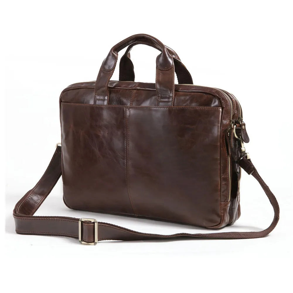Brown cowhide leather business briefcase open showing interior polyester cotton lining and 18-inch laptop storage