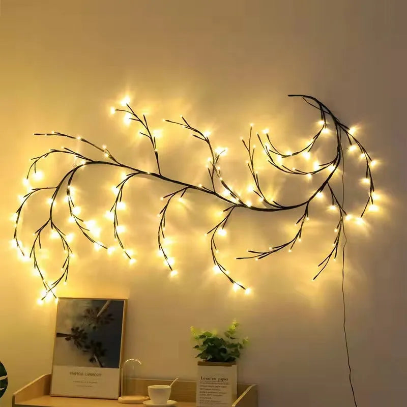 Flexible willow vine LED garland with warm white lights and white birch bark texture, bent into a decorative shape.