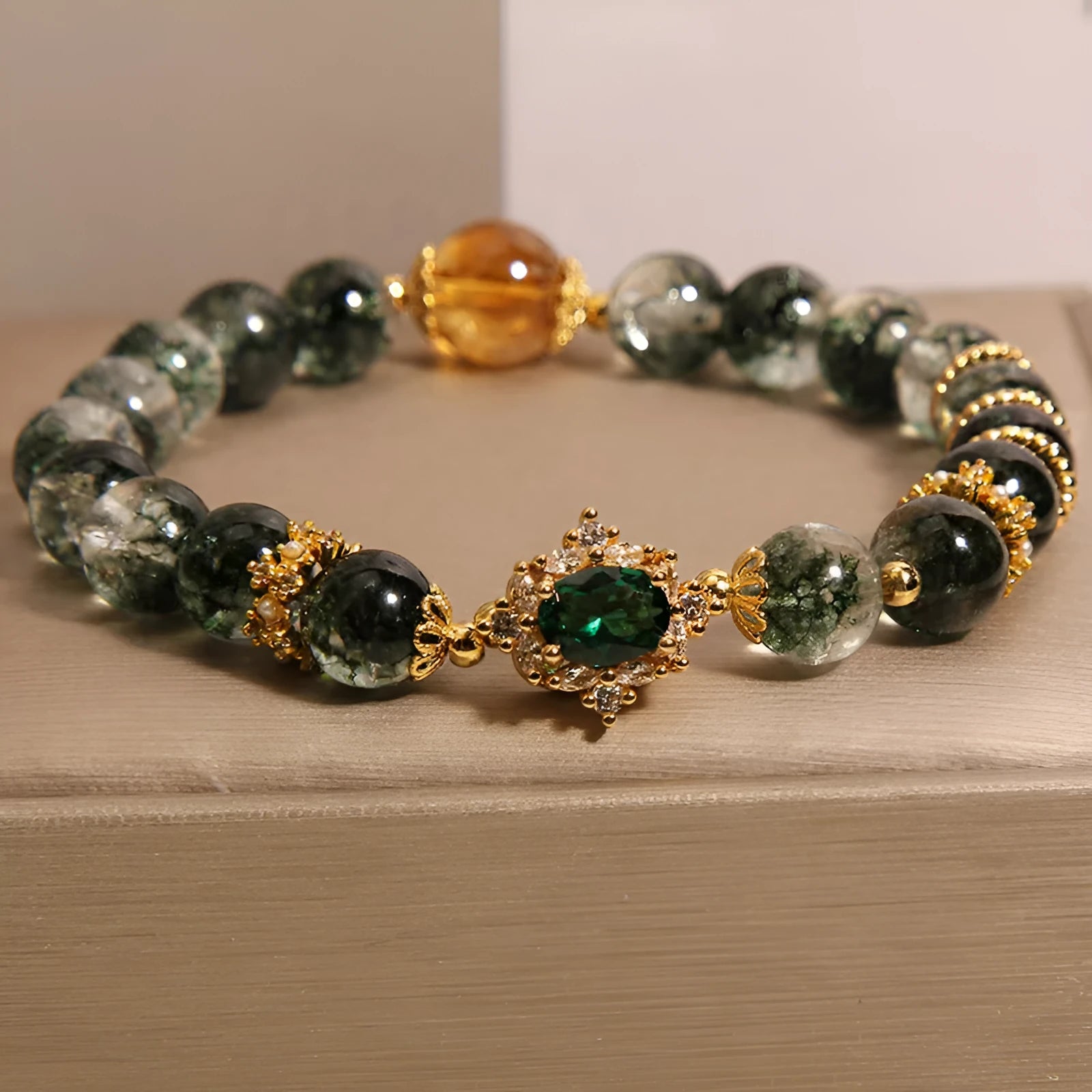 Gold rutilated quartz bracelet with green phantom quartz beads, gold ruby quartz accents, pearl and rhinestone details