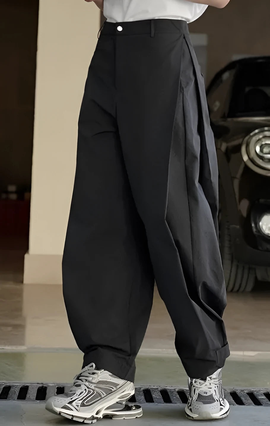 Black women's casual trousers with high-waisted pleated front and loose wide-leg silhouette