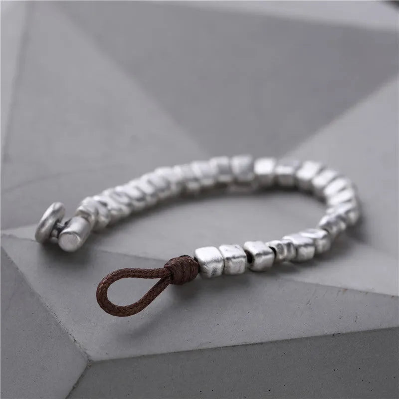 Handmade silver women's bracelet with wooden accents and irregular square design