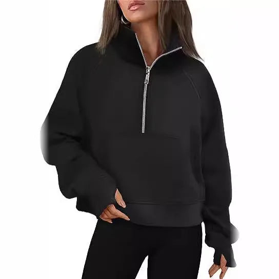 A woman wearing a loose-fitting apricot-coloured fleece-lined sweater with a lapel neckline and raglan sleeves.
