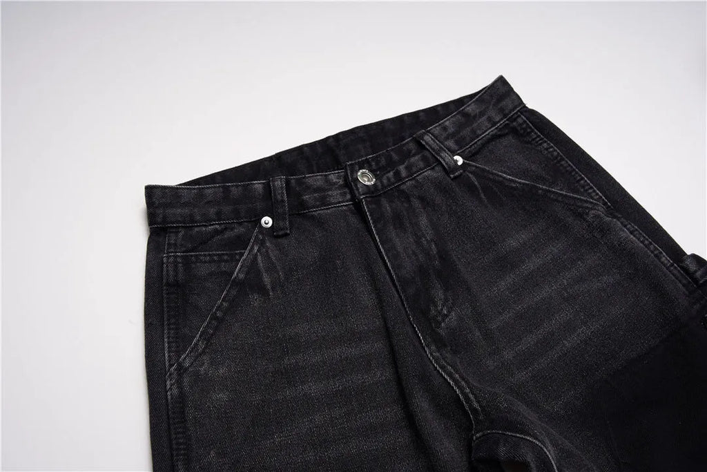 Black micro flared patchwork raw edge jeans on model showing loose straight tube fit
