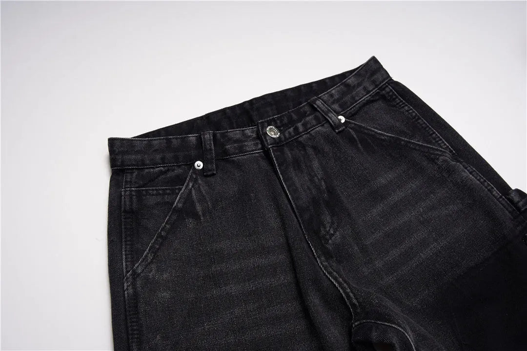 Black micro flared patchwork raw edge jeans on model showing loose straight tube fit