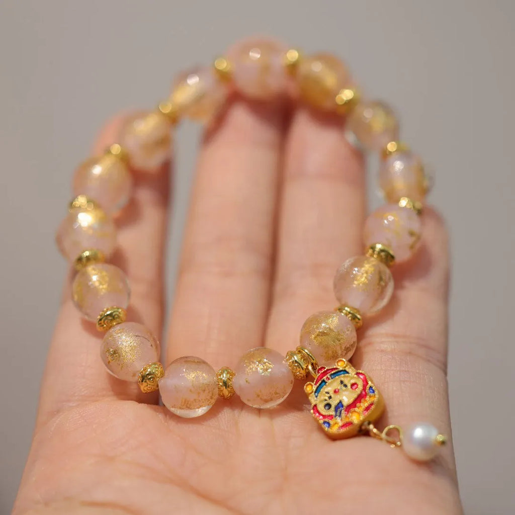 Women's ethnic bracelet with gold foil coloured glaze geometric design in pink or red colour options