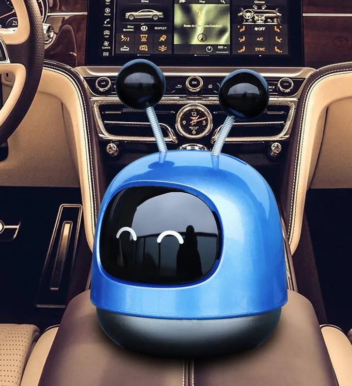 Robot-shaped car vent air freshener ornament in blue, grey or red with gel fragrance.