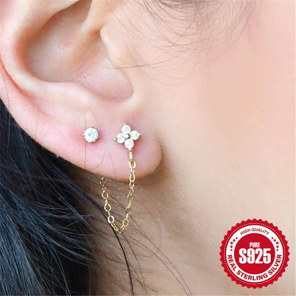 S925 sterling silver stud earring with a diamond-shaped flower, dangling tassel, and chain detail in a golden colour.
