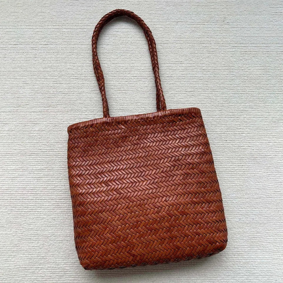 Brown handmade woven cowhide leather tote bag with a three-dimensional front pocket.
