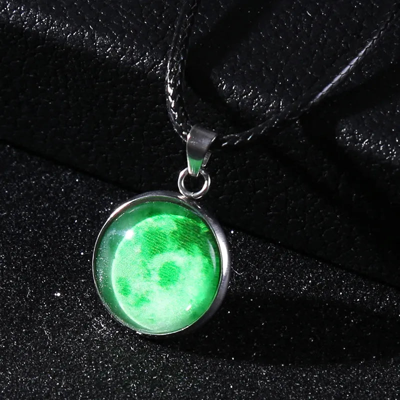 Luminous moon and constellation glass pendant on a silver alloy necklace chain with an extension piece.