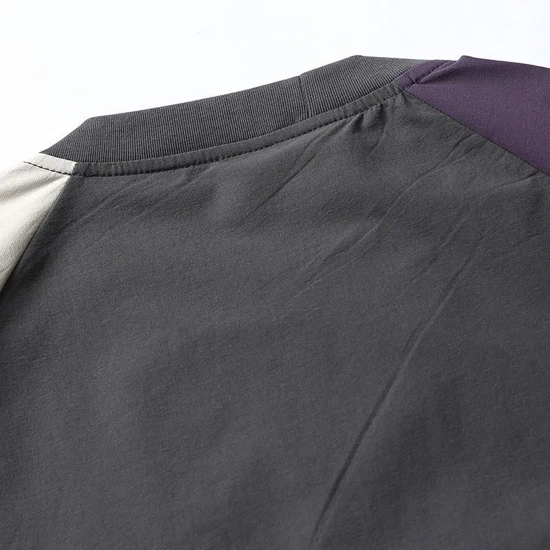 Dark grey men's loose fit t-shirt with contrasting raglan sleeves on a hanger.