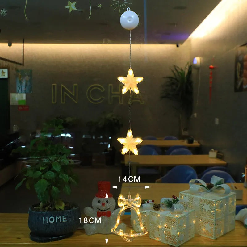 Three Christmas LED light ornaments with suction cups hanging on window