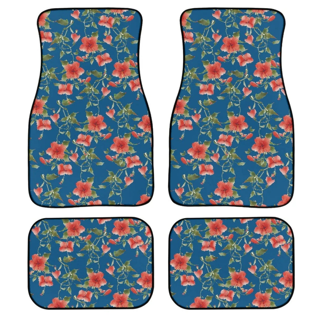 Set of four black printed rubber car floor mats with textured surface, showing thickness.