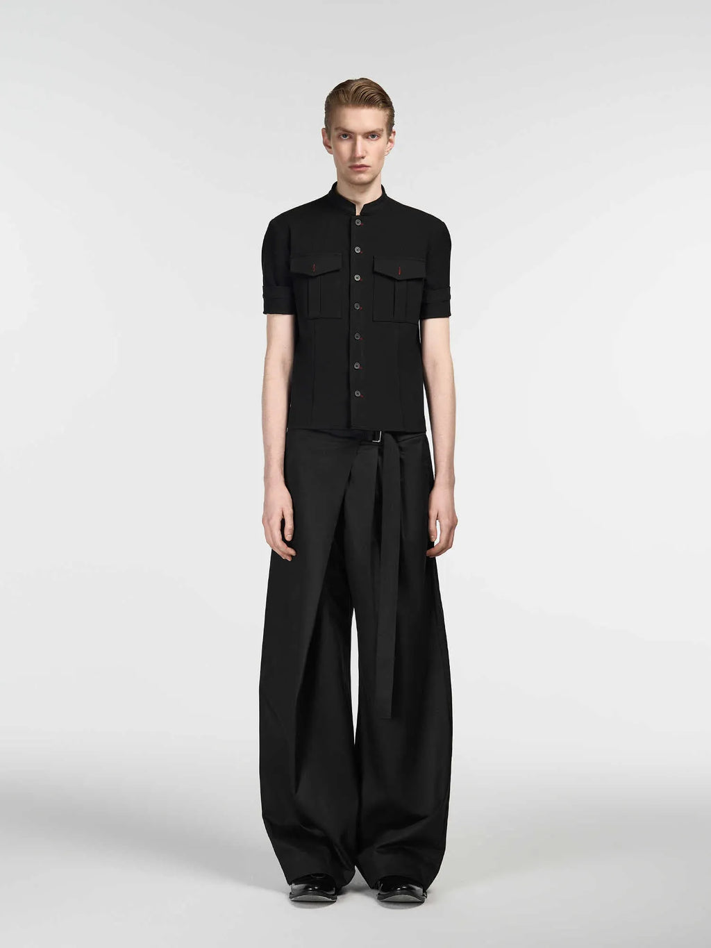 Black loose fit straight-leg trousers with single pleat front and adjustable waistband