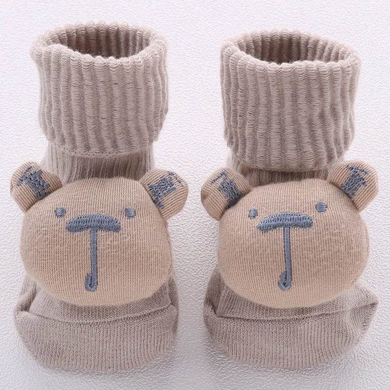 Cotton baby floor socks in a pink bow pattern, shown on an infant's feet.