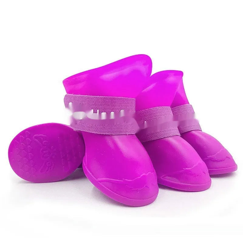 Set of four anti-slip pet rain shoes in various colours with rubber soles for waterproof dog paw protection.