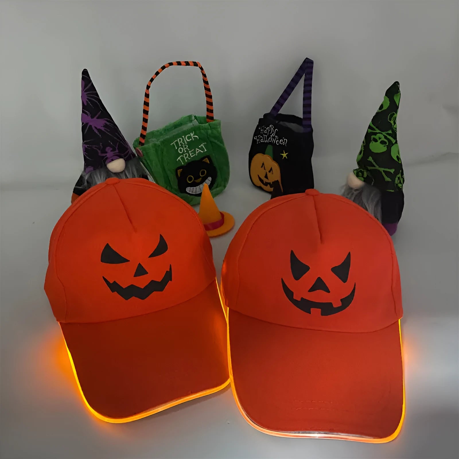 Halloween LED light-up baseball cap showing pumpkin smile yellow light pattern on a black cloth cap with adjustable strap.