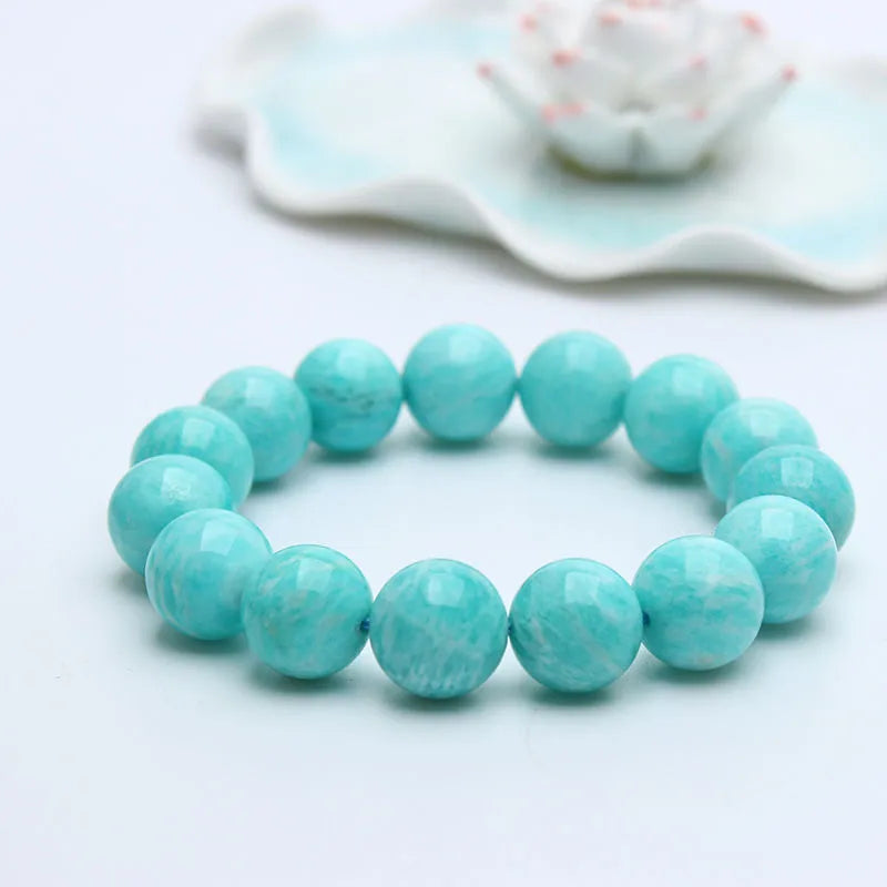 Blue-green amazonite stone beaded bracelet with adjustable string closure.