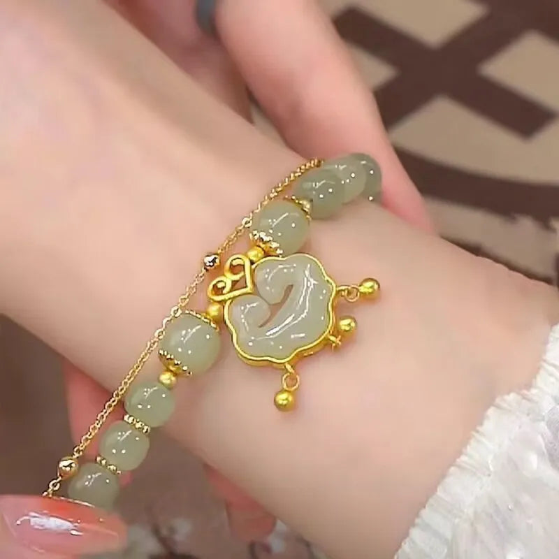Green women's bracelet with traditional Chinese xiangyun lock pendant and safety closure