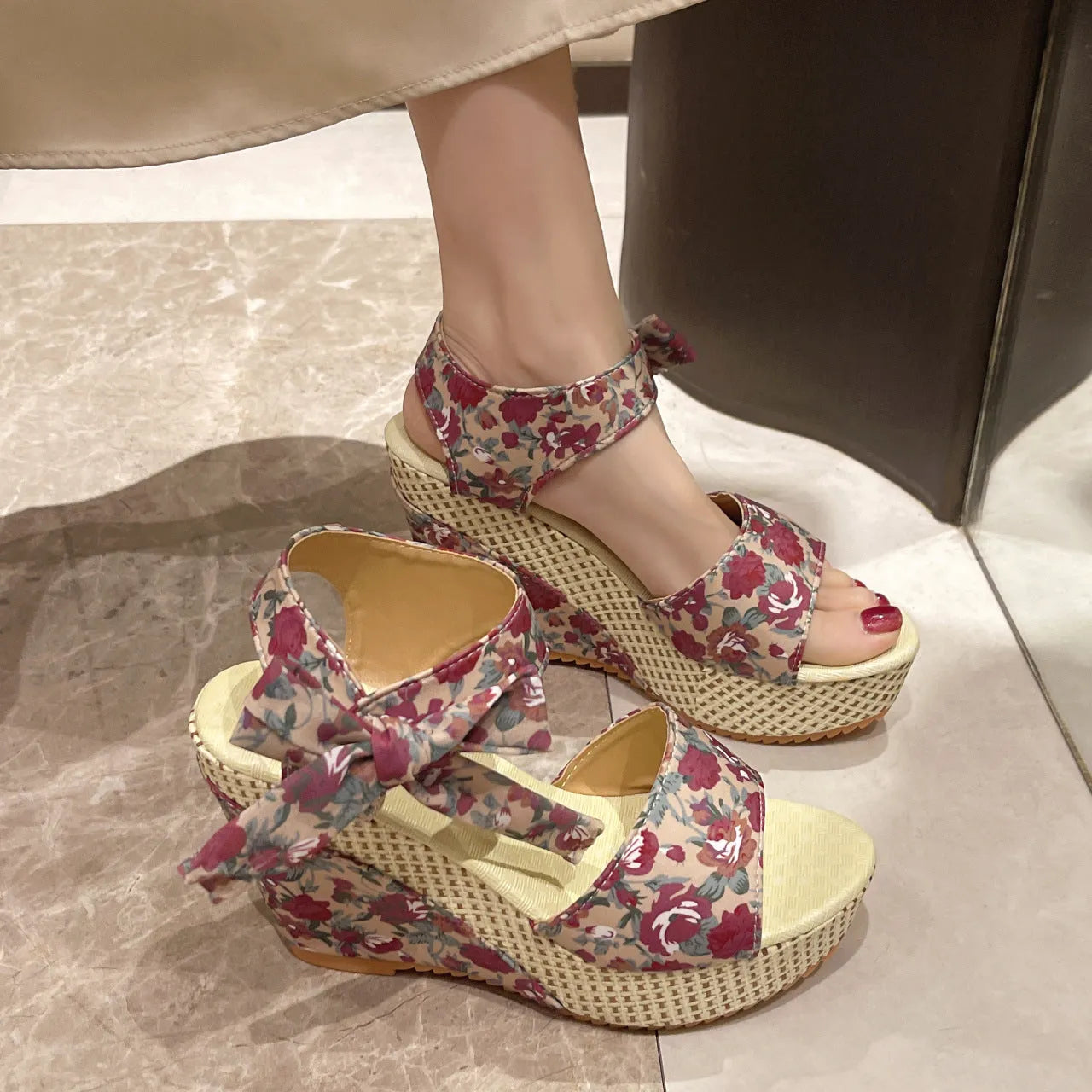 Women's floral patterned peep toe wedge sandals with an ankle strap buckle.