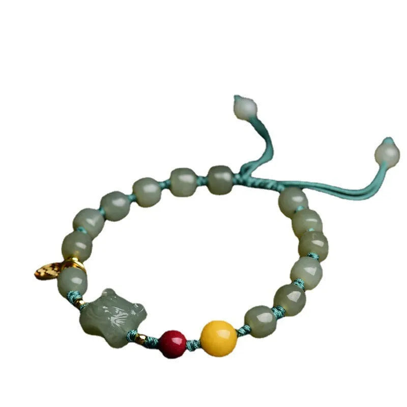 Natural Hetian jade bracelet with zodiac modelling, cinnabar and beeswax beads, and sequin detail.